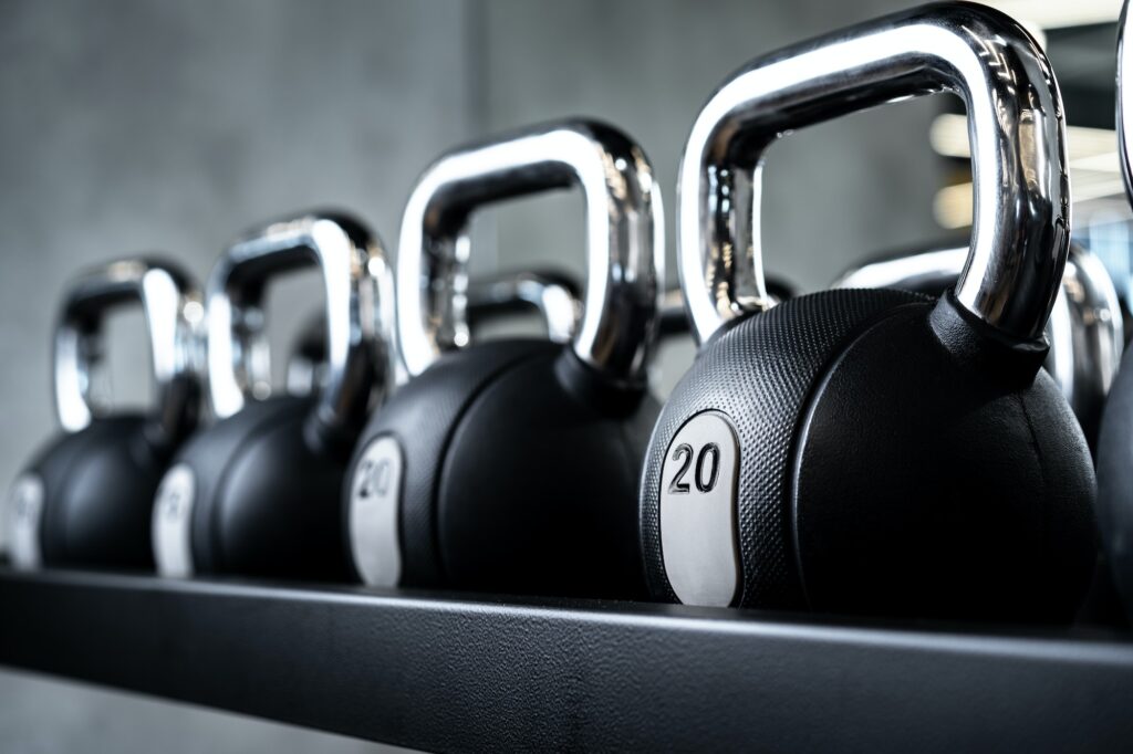 Fitness Factory Assen | Close up of new dumbbells on a rack in a gym